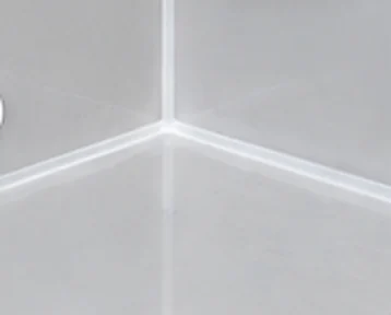 After: fresh, mould-resistant silicone in the same corner