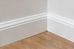 White skirting board neatly caulked at a timber floor