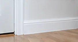 Freshly caulked white skirting boards